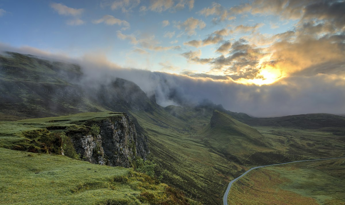 Golden hour light on misty mountains