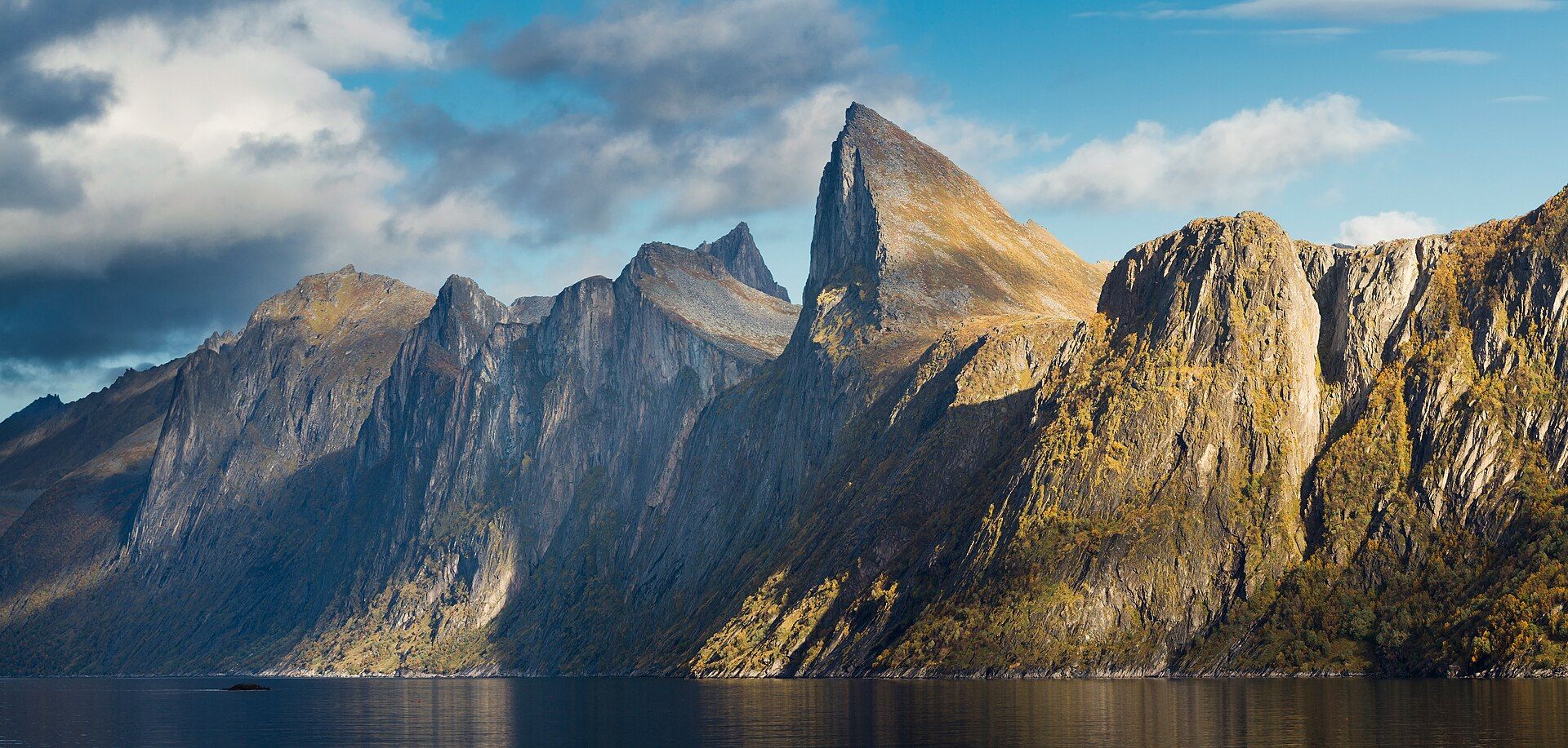 The sharp peak of Segla rising above Mefjorden on Senja in September light